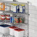 A Regency stainless steel wall-mount shelf with food containers and cans on it.