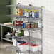 A Regency stainless steel wall-mounted wire shelf with food items on it.