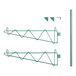 A pair of green metal Regency shelf brackets with a white background.