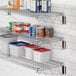 A kitchen with a Regency chrome wire shelf holding food containers and plastic bins.