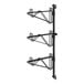 A black metal Regency wall-mount shelf post with double brackets for three shelves.