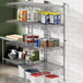 A Regency stainless steel wall-mount shelf with food items on it.