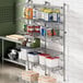 A Regency stainless steel wall-mount middle shelf post with double brackets holding shelves.
