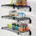 A Regency black epoxy wire shelf holding snacks and snacks.