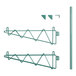 A pair of green metal brackets with double triangles.