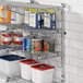 A Regency chrome wire shelf with food containers and cans on the wall.