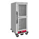 An Avantco stainless steel holding cabinet with clear Dutch doors.