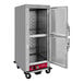 An Avantco metal holding cabinet with clear Dutch doors open.