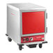 A red and white Avantco holding cabinet with wheels.