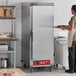 A full size insulated heated holding cabinet with a solid stainless steel door, designed for commercial kitchen use.