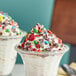 Two dessert cups with M&M'S on top of ice cream.