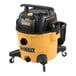 A close up of a black and yellow DeWalt wet/dry vacuum with yellow handle.