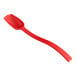 A red polycarbonate salad bar spoon with a handle.