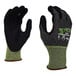 A pair of small black and green Cordova Tactyle gloves with Tuf-Cor sandy nitrile palm coating.