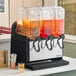 A triple 5-gallon bowl refrigerated beverage dispenser with three clear containers and black dispensing handles, designed for serving cold drinks.
