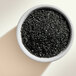 A bowl of black Adourne sparkling sugar.