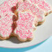 A plate of cookies with pink sparkling sugar.