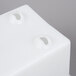 A white square plastic holder with two holes.