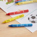 A group of Choice hexagonal kids' restaurant crayons on a table.