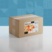 A brown cardboard box of Adourne Coarse Orange Sanding Sugar with a label.
