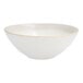 A Nosse by Fortessa ivory stoneware bowl with a gold rim.