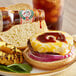 A cheeseburger with grilled pineapple and Pickapeppa Original Sauce on a plate.