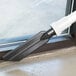 A ProTeam vacuum cleaner with a black and white tool attachment kit.