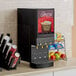 A Curtis Cafe Series cappuccino machine on a counter with a cup of cappuccino.