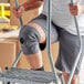 A person wearing a 3M Futuro knee support on stairs.