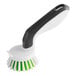 A white and green 3M Scotch-Brite Little Handy Scrubber brush with a handle.
