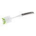 A 3M Scotch-Brite glass brush with a white and green handle and brush head.