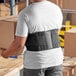 A man wearing a 3M Futuro back support belt.