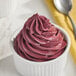 A bowl of red Makai Acai soft serve with a spoon.