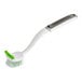 A 3M Scotch-Brite pot and pan brush with a white and green handle.