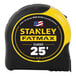 A Stanley FATMAX yellow and black 25' tape measure on a table.