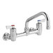 A silver Fisher wall-mount faucet with lever handles and an 8" swing nozzle.