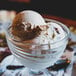 A bowl of vanilla ice cream with a scoop of ice cream on top.