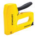 A Stanley yellow and black heavy-duty manual staple gun.