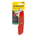 A Stanley self-retracting safety utility knife with a red handle and round-point blade in packaging.