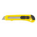 A yellow and black Stanley plastic retractable snap-blade utility knife with a black handle.