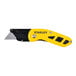 A Stanley yellow and black metal compact utility knife with a heavy-duty blade.
