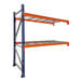 A blue and orange Interlake Mecalux heavy-duty bolted pallet rack add-on with wire deck shelves.