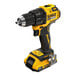 A yellow and black DeWalt cordless drill with a battery and charger.