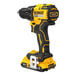 A yellow and black DeWalt cordless drill with battery and charger.