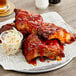 A plate of ribs with Capital City Mambo sauce and coleslaw.