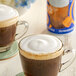 A cup of coffee with International Delight Caramel Cold Foam Creamer.