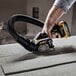 A person using a DeWalt 3" compact cut-off tool.