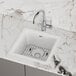 A Zurn Elkay white quartz bar sink on a counter.