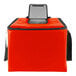 A red insulated milk crate bag with a black strap.