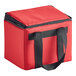 A red insulated food carrier with black straps.